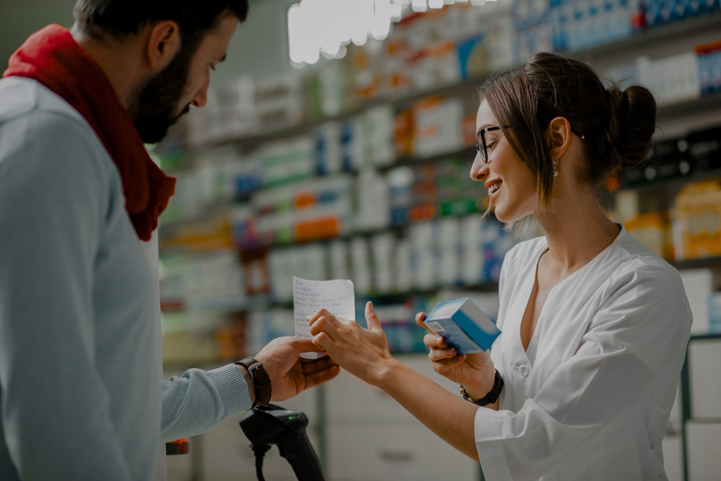 Pharmacist helping a customer in a community pharmacy